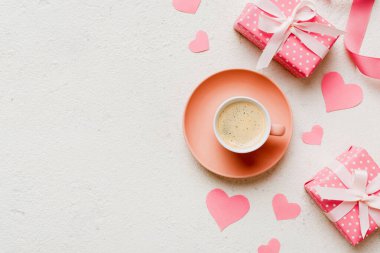 Mug coffee and gift box on colored background. Flat lay composition. Holiday concept.