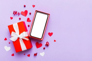 Opened gift box with ribbon and phone on color background, top view. Blank open box packaging mockup , Template for your design - branding mockup.