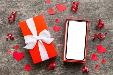 Opened gift box with ribbon and phone on color background, top view. Blank open box packaging mockup , Template for your design - branding mockup.