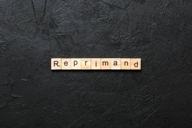 reprimand word written on wood block. reprimand text on table, concept.