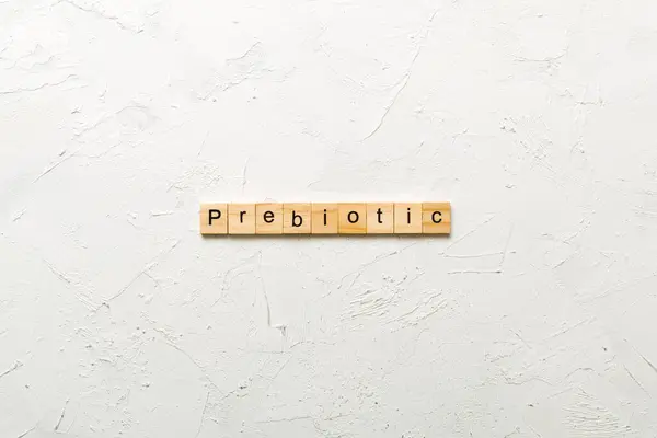stock image prebiotic word written on wood block. prebiotic text on table, concept.