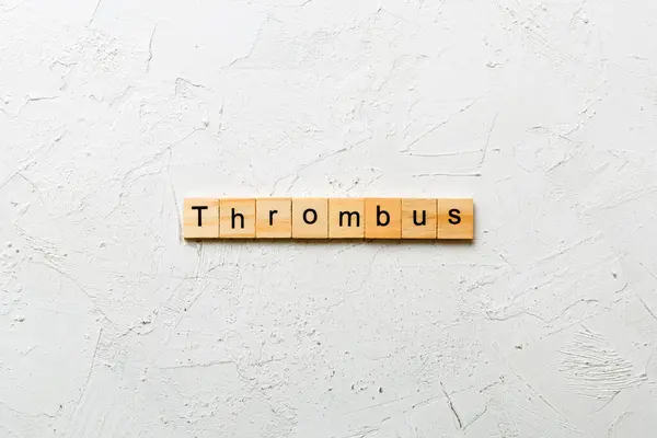 stock image thrombus word written on wood block. thrombus text on table, concept.