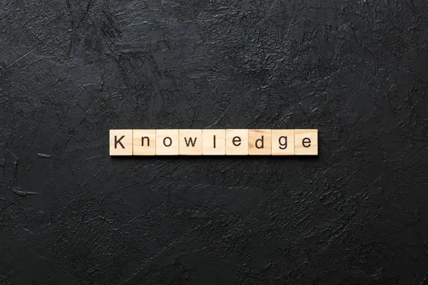 stock image Knowledge word written on wood block. Knowledge text on cement table for your desing, concept.