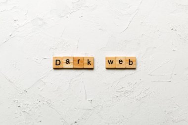 Dark web word written on wood block. Dark web text on cement table for your desing, concept. clipart