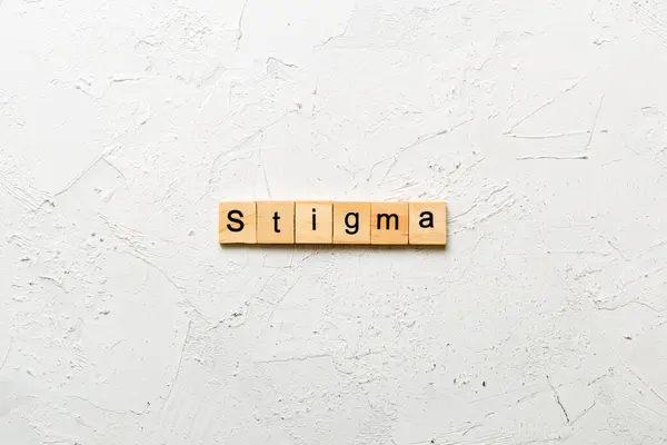 stock image stigma word written on wood block. stigma text on table, concept.