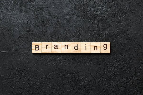 branding word written on wood block. branding text on table, concept.