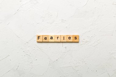 Fearless word written on wood block. Fearless text on cement table for your desing, concept. clipart