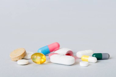 Many different colorful medication and pills perspective view. Set of many pills on colored background.