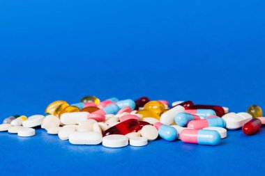 Many different colorful medication and pills perspective view. Set of many pills on colored background.