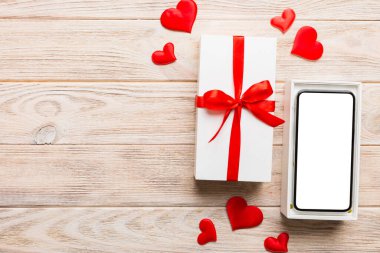 Opened gift box with ribbon and phone on color background, top view. Blank open box packaging mockup , Template for your design - branding mockup.