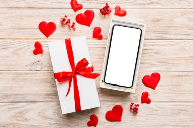 Opened gift box with ribbon and phone on color background, top view. Blank open box packaging mockup , Template for your design - branding mockup.