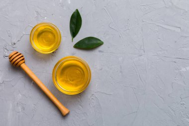 Bal kavanozu, beyaz arka plan manzaralı ve fotokopi alanı olan ahşap bal kaplama. Lezzetli bal şişesi.