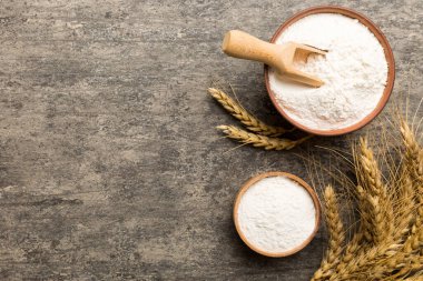 Tahta kasede buğday unu ve renkli arka planda buğday dikenleri. dünya buğday krizi.