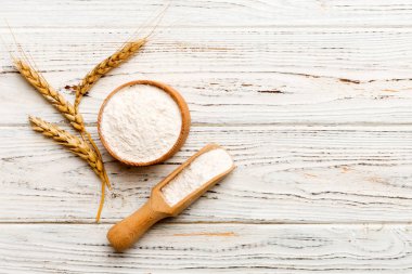 Tahta kasede buğday unu ve renkli arka planda buğday dikenleri. dünya buğday krizi.