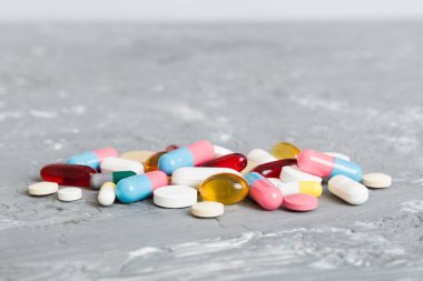 Collection Of Various Medical Tablets And Pills. Assorted pharmaceutical medicine pills, tablets and capsules on table background. Heap of assorted various medicine tablets. Health care.