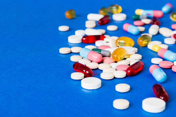 Many different colorful medication and pills perspective view. Set of many pills on colored background.