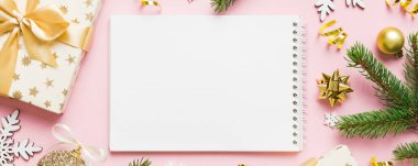 Christmas blank greeting card mock-up scene. Creative layout made of Christmas tree branches and paper card note. Flat lay. Nature New Year concept.