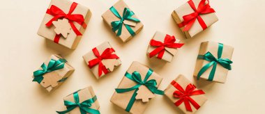 Colored craft gift boxes with colorful ribbons on colored background. Collection of Christmas present boxes .