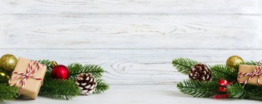 New Year Christmas mood, gift box, branches of a christmas tree, New Year decorations on a colored background.