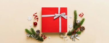 Top view Flat lay Christmas decorations and gift box on colored background with copy space. Christmas or Happy New Year composition.
