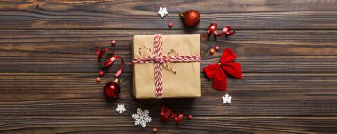 Top view Flat lay Christmas decorations and gift box on colored background with copy space. Christmas or Happy New Year composition.