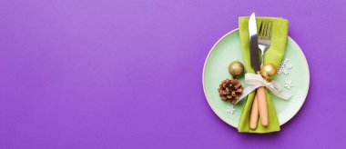 Noel süsleri, tabaklar, inekler, çatallar ve kaşıklarla Noel sofrası. Noel tatili geçmişi. Kopyalama alanı olan üst görünüm.