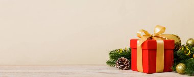 New Year Christmas mood, gift box, branches of a christmas tree, New Year decorations on a colored background.