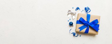 Top view Flat lay Christmas decorations and gift box on colored background with copy space. Christmas or Happy New Year composition.