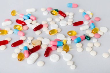 Many different colorful medication and pills perspective view. Set of many pills on colored background.