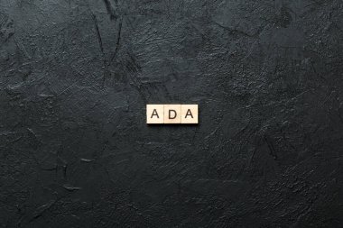 ADA word written on wood block. ADA text on table, concept.