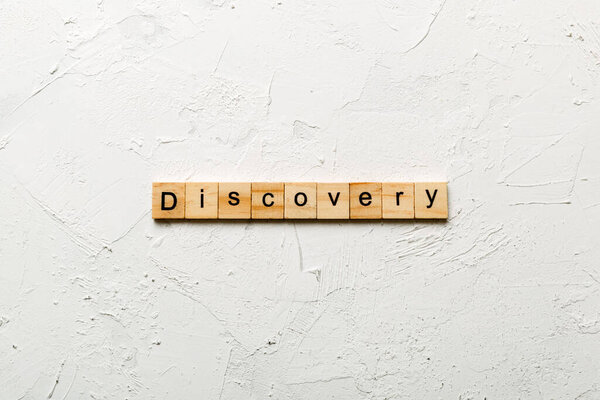 discovery word written on wood block. discovery text on table, concept.