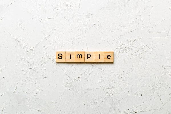 simple word written on wood block. simple text on table, concept.