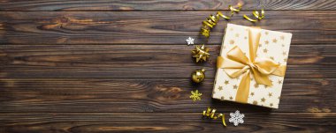 Top view Flat lay Christmas decorations and gift box on colored background with copy space. Christmas or Happy New Year composition.