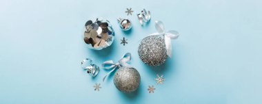 Christmas ball on colored background. decoration bauble with ribbon bow with copy space.