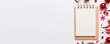 Christmas blank greeting card mock-up scene. Creative layout made of Christmas tree branches and paper card note. Flat lay. Nature New Year concept.