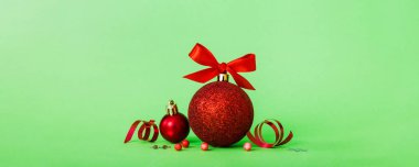 Christmas ball on colored background. decoration bauble with ribbon bow with copy space.