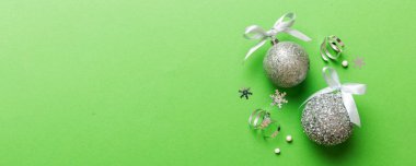 Christmas ball on colored background. decoration bauble with ribbon bow with copy space.