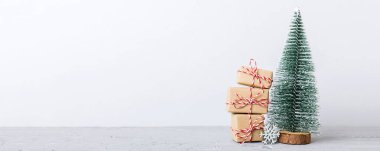 Christmas composition. Gifts, small tree, branches and craft DIY decorations on white background. New year concept. Christmas home decoration Flat lay, top view, copy space.