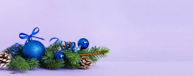 New Year Christmas tree toy, branches of a christmas tree, New Year decorations on a colored background.