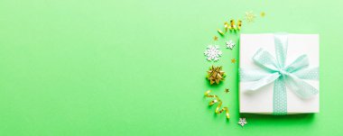 Top view Flat lay Christmas decorations and gift box on colored background with copy space. Christmas or Happy New Year composition.