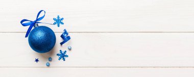 Christmas ball on colored background. decoration bauble with ribbon bow with copy space.