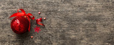 Christmas ball on colored background. decoration bauble with ribbon bow with copy space.