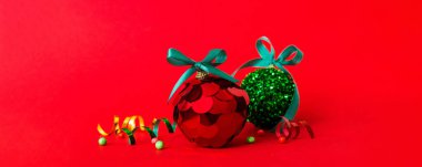 Christmas ball on colored background. decoration bauble with ribbon bow with copy space.