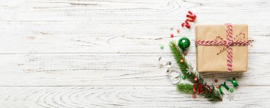 Top view Flat lay Christmas decorations and gift box on colored background with copy space. Christmas or Happy New Year composition.