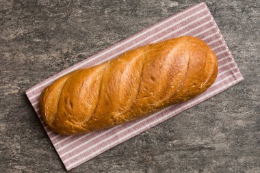 Kırsal masa manzaralı peçeteli taze pişmiş ekmek. Sağlıklı beyaz ekmek izole edilmiş..