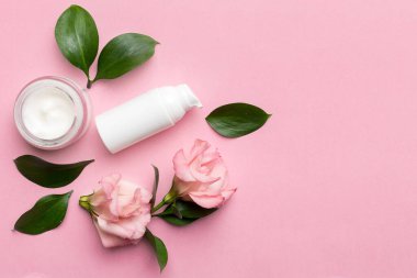 Kozmetik ürünleri ve ahşap arka planda güzel güller olan kompozisyon. Uzayı kopyala, düz yat.