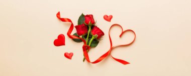 Masada gül çiçeği ve kırmızı kalple Sevgililer Günü kompozisyonu. Üst görünüm, düz görünüm, kopyalama alanı Tatil kavramı.