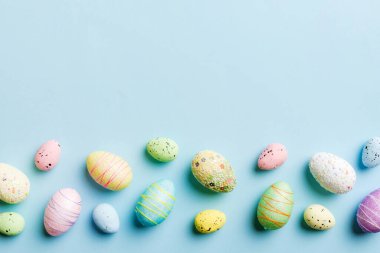 Happy Easter concept. Preparation for holiday. Easter eggs on colored background. flat lay top view copy space banner.