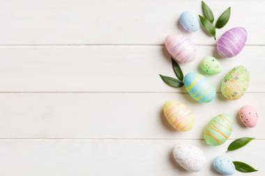 Happy Easter concept. Preparation for holiday. Easter eggs on colored background. flat lay top view copy space banner.