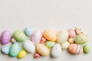 Happy Easter concept. Preparation for holiday. Easter eggs on colored background. flat lay top view copy space banner.